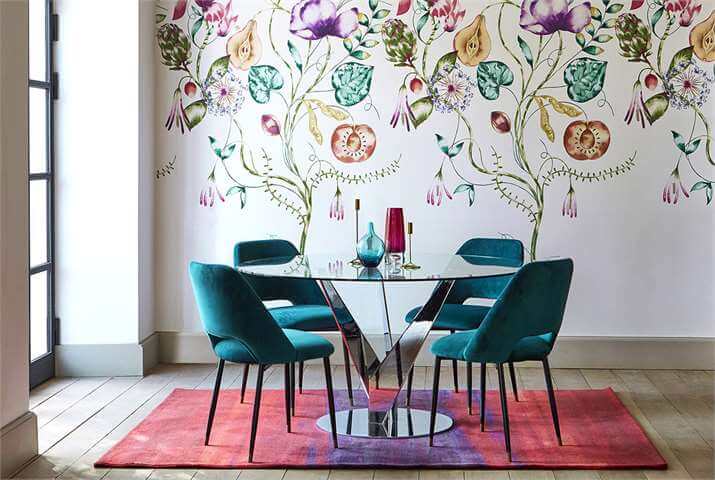 Beautifully-designed room with four turquoise-colored chairs and a glass table.