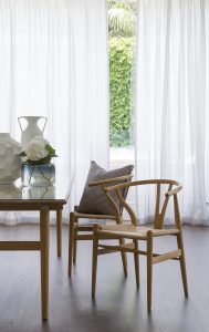 A room with a white extra long curtain installed by Katandra Interiors Busselton.