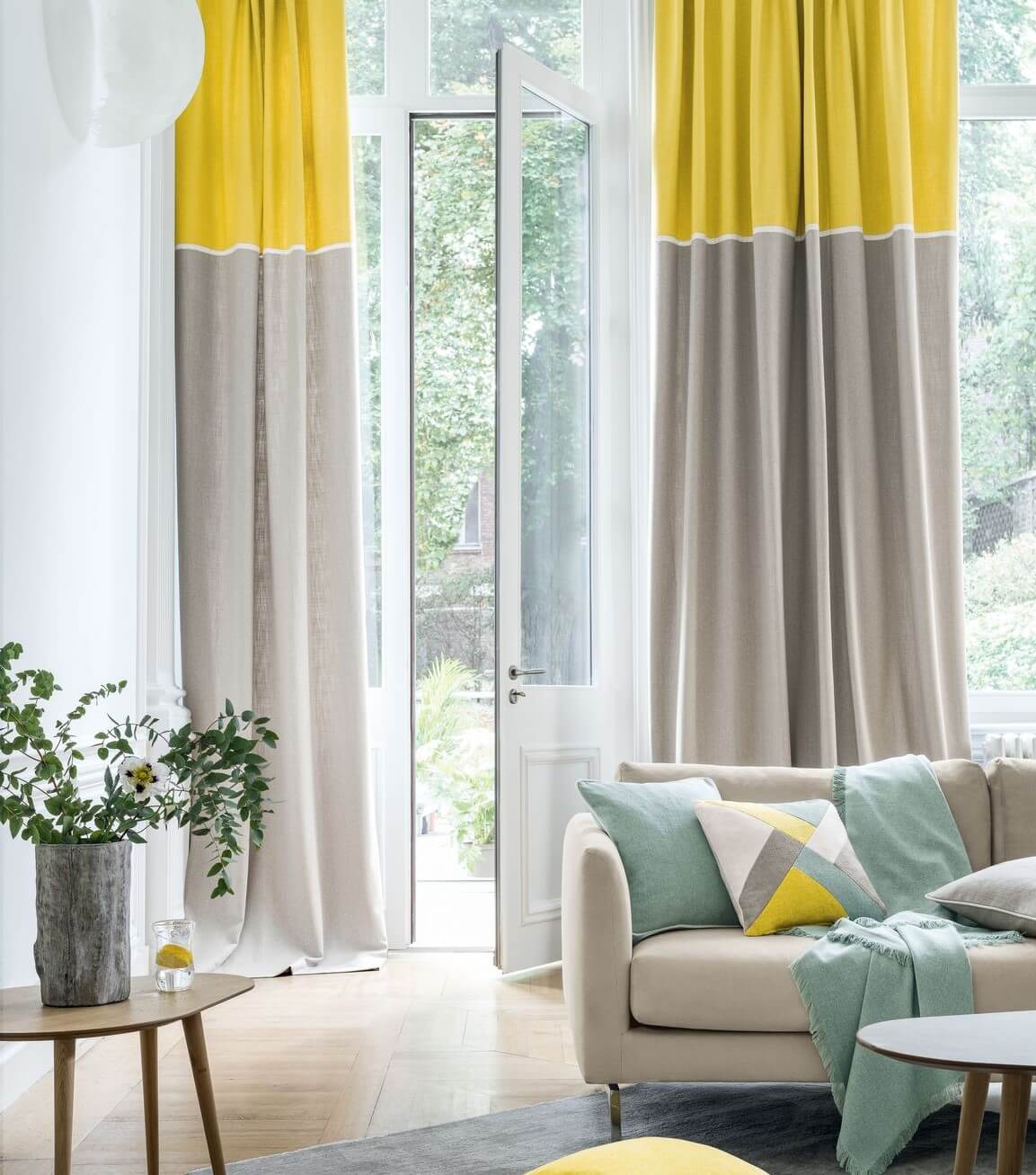 Beautiful yellow, grey, and green-designed room with a beautiful drapes done by Katandra Interiors Busselton.